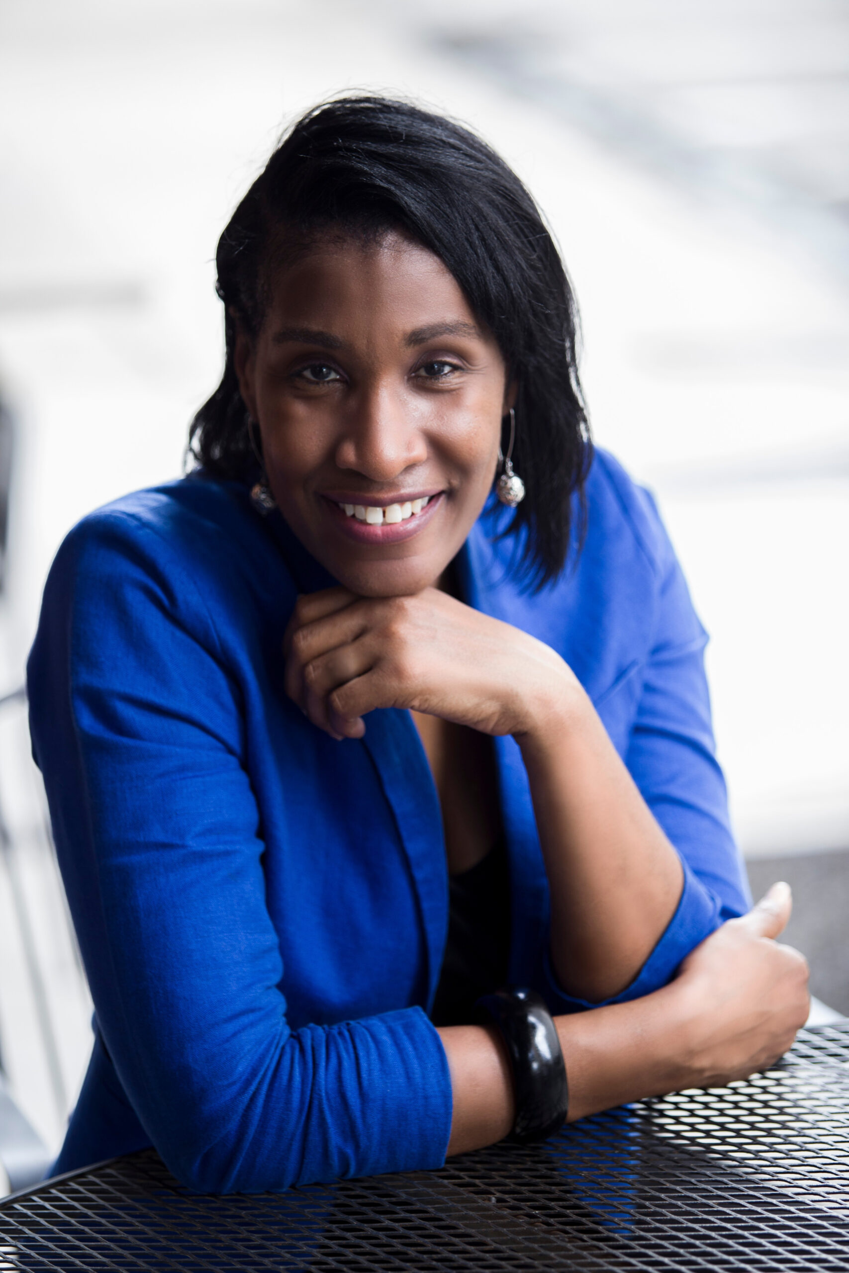 headshot of Virnitia in a blue blazer.