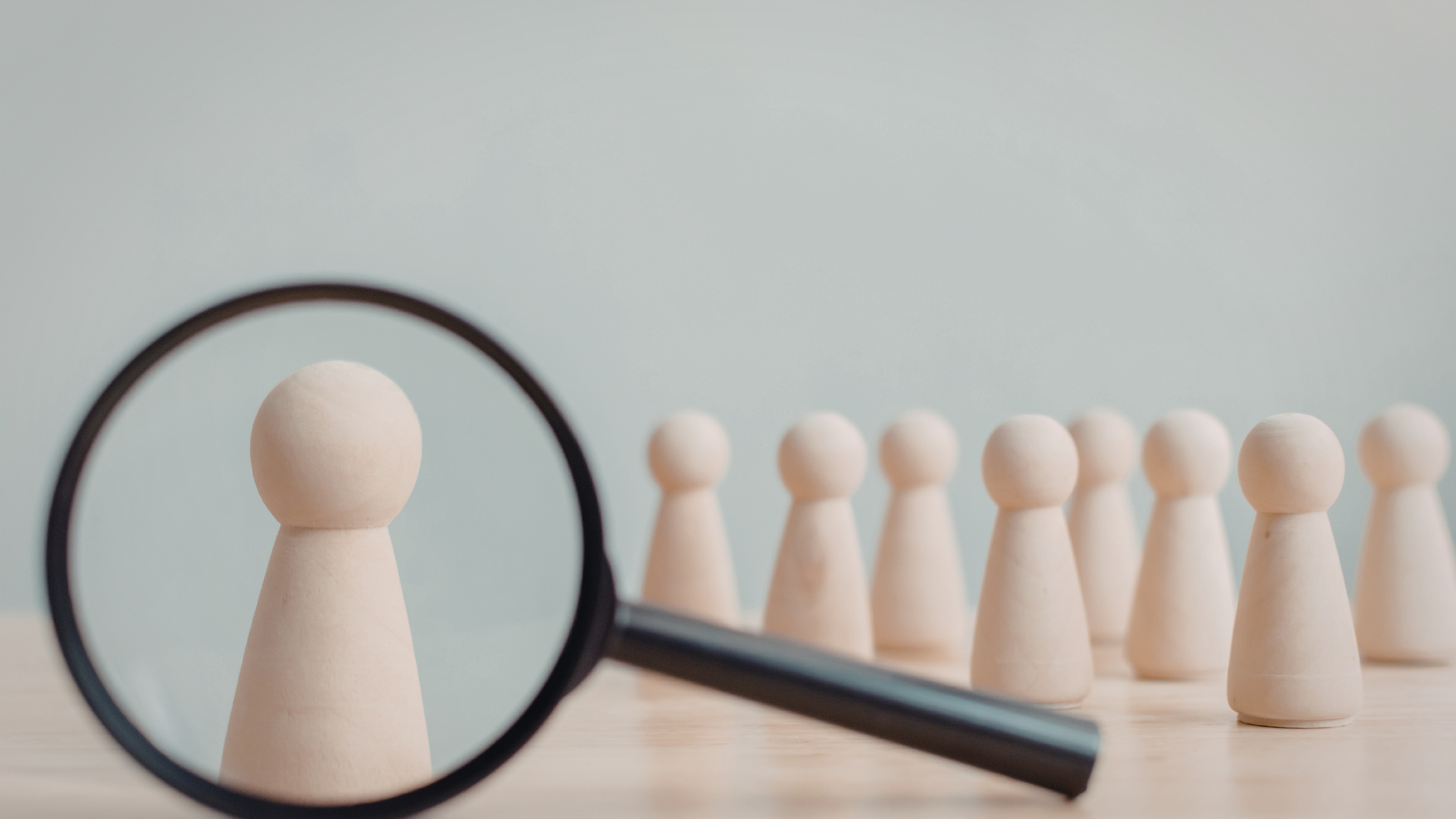 magnifying glass over chess pieces in color